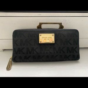 Black Micheal Kors Black signature large zipper wallet. Gold hardware.